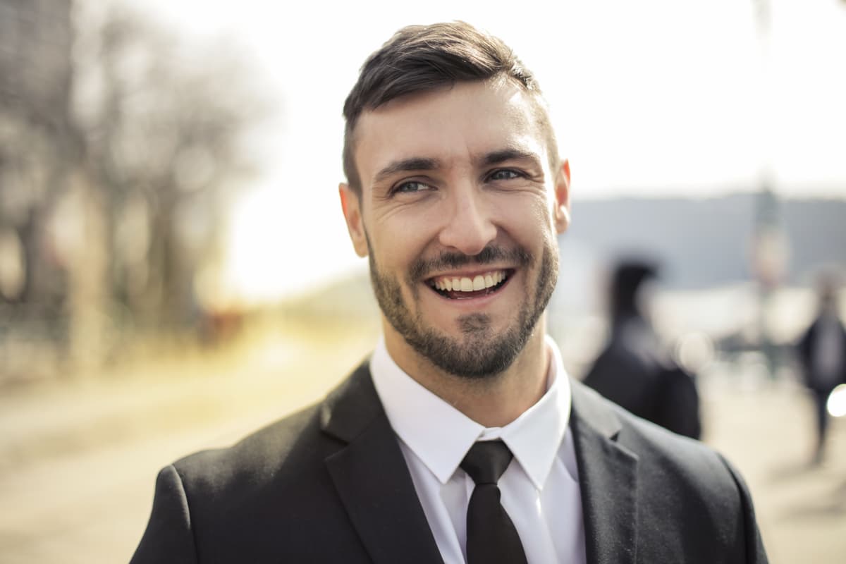 corporate headshot, man in suit, gray background, professional