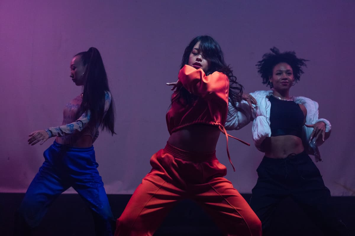 event photography, dancers on stage, vibrant colors, dynamic