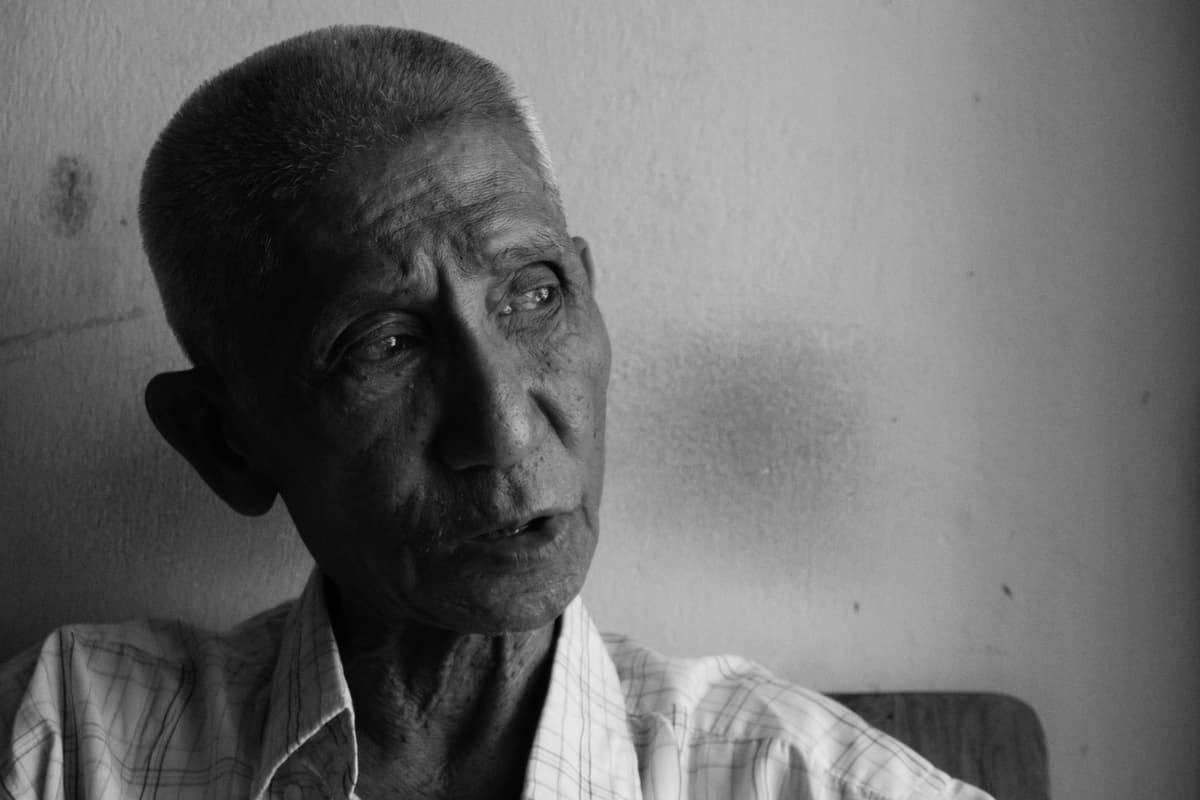 black and white portrait, elderly man, textured wall, timeless