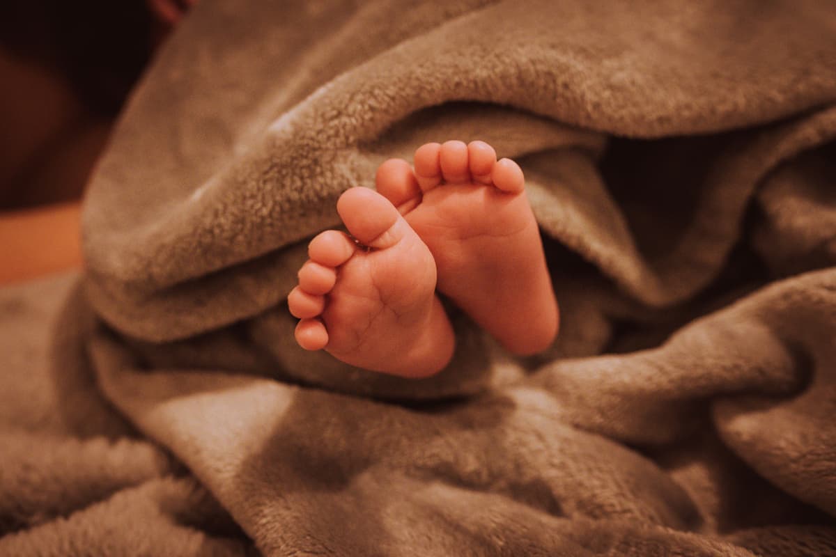 newborn baby sleeping, soft blanket, close-up, tender